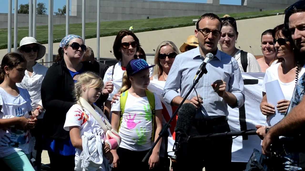 Adam speaks to a rally of single parents at Parliament House.