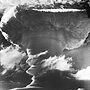 The tall mushroom cloud of a British hydrogen bomb that was detonated over Kiritimati in 1957.