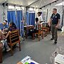 candid shot of inside of tent clinic triaging patients