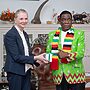 UN Women Executive Board President Nicola Clase of Sweden shakes hands with Zimbabwe President E.D. Mnangagwa