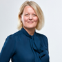 Alison Rose with blonde hair wearing a dark blue blouse and smiling.