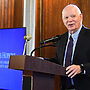 Sen. Ben Cardin speaks from a podium at Evergreen House