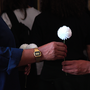 Two people passing a white flower between them