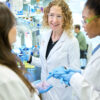 Christina Stallings, PhD (center), works with Kate Wardenburg (left), an MD/PhD student in the Medical Scientist Training Program, and Ananda Rankin, a graduate student in the Roy and Diana Vagelos Division of Biology & Biomedical Sciences, in the Stallings lab at the Steven & Susan Lipstein BJC Institute of Health. (Photo: Matt Miller/WashU Medicine)