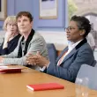 Women leaders, Tania Rhodes-Taylor, Professor Rachel A. Mills, and Professor Funmi Olonisakin, gathered around a conference table.